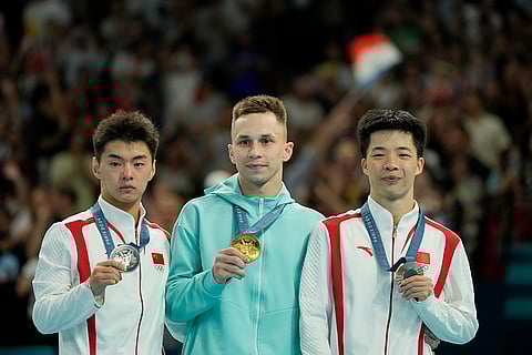 Bronze medalist Yan Langyu, gold medalist Ivan Litvinovich and silver medalist Wang Zisai